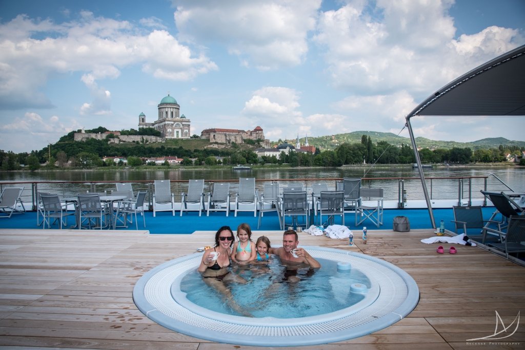Family of four sitting in the jacuzzi on the Primadonna river boat.