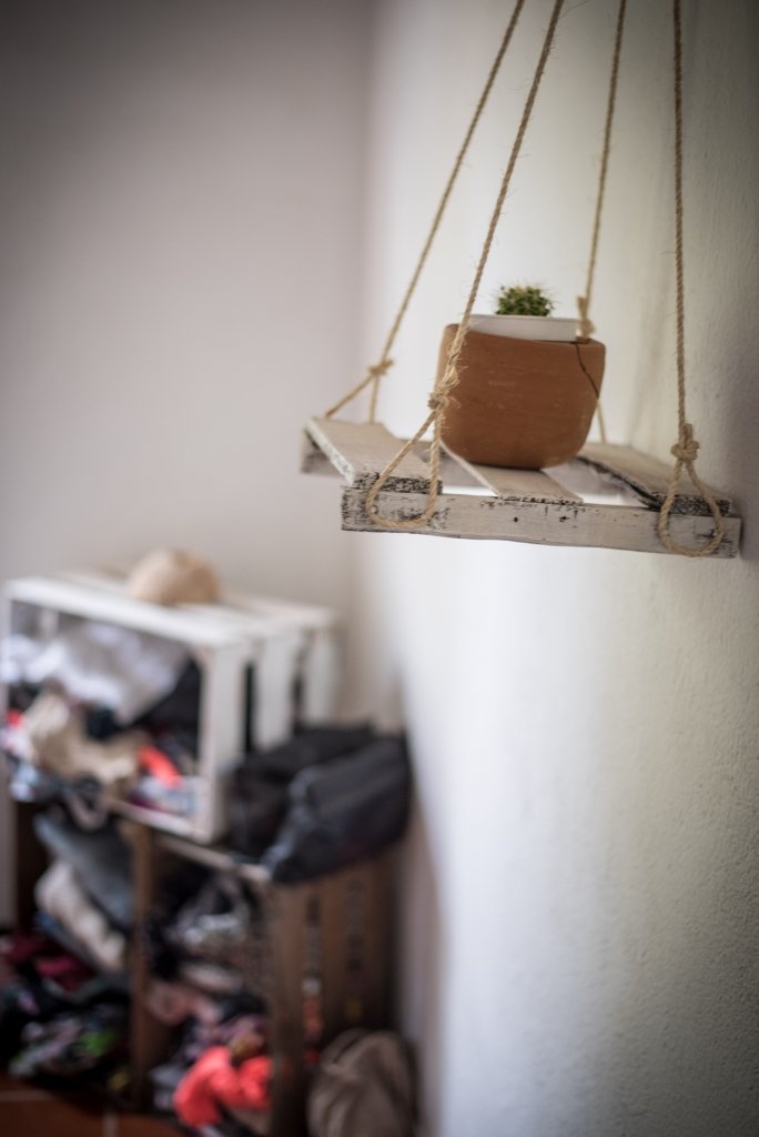 hanging planter with wood crate clothing storage