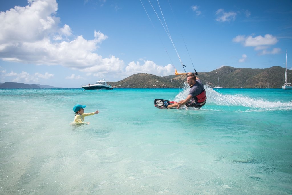 Kiteboarding Sandy Spit, BVI. Coming in for a high-five from Ellia who was playing in the water.