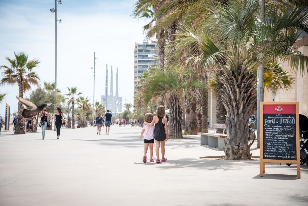 Kids walking the boardwalk in Badalona, Spain