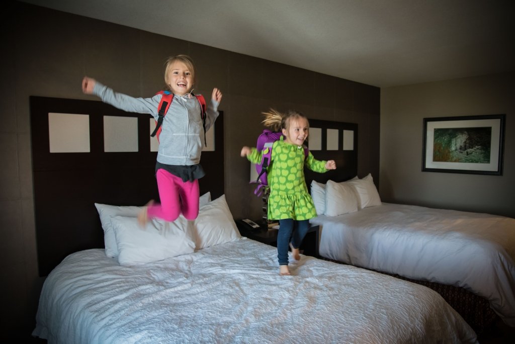 Kids jumping on hotel bed